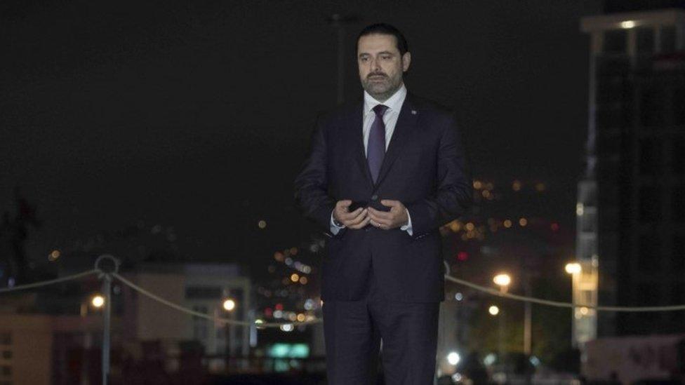 Lebanese Prime Minister Saad Hariri praying over his father's grave in Beirut (21 November 2017)