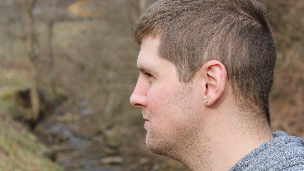 Image shows Jason Walker next to the stream near his home in West Virginia