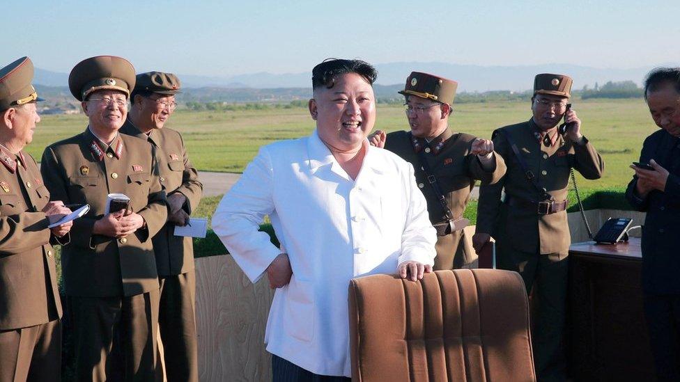 North Korean leader Kim Jong-un watches the test of a new-type anti-aircraft guided weapon system organised by the Academy of National Defence Science in this undated photo released by North Korea's Korean Central News Agency