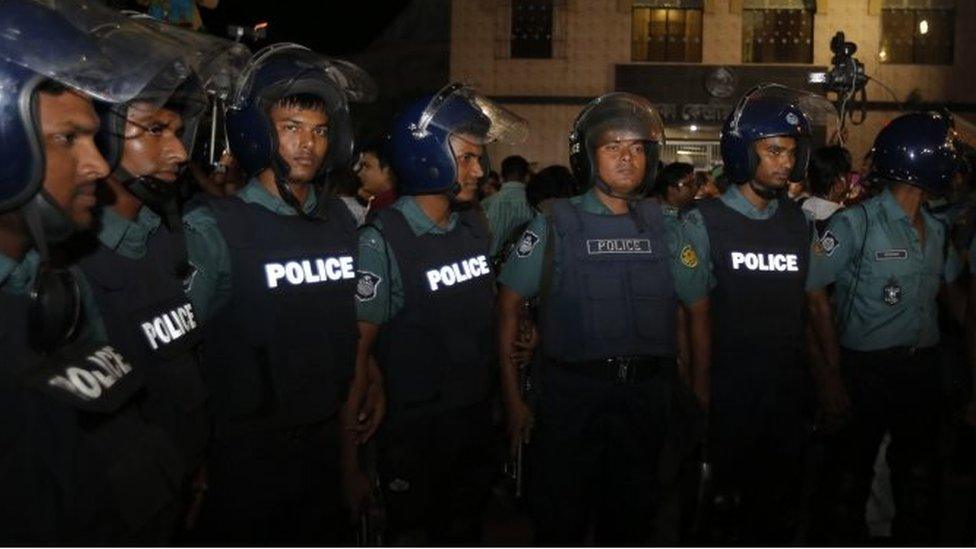 Police officers stand guard outside Dhaka's prison