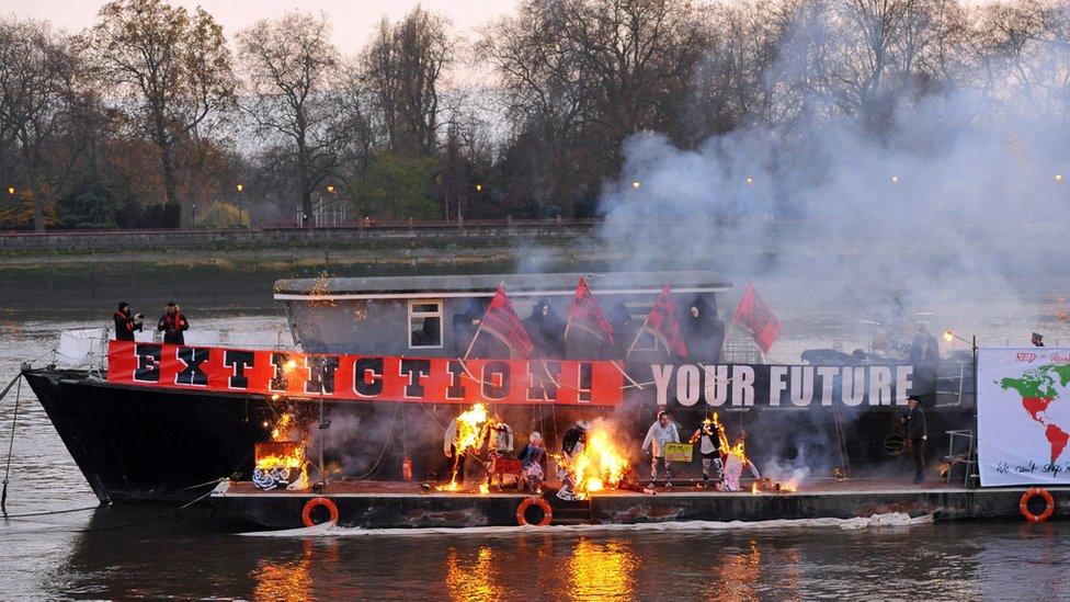 A boat with burning memorabilia on the river thames