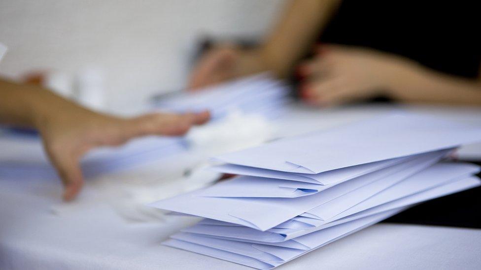 Child's hand and envelopes