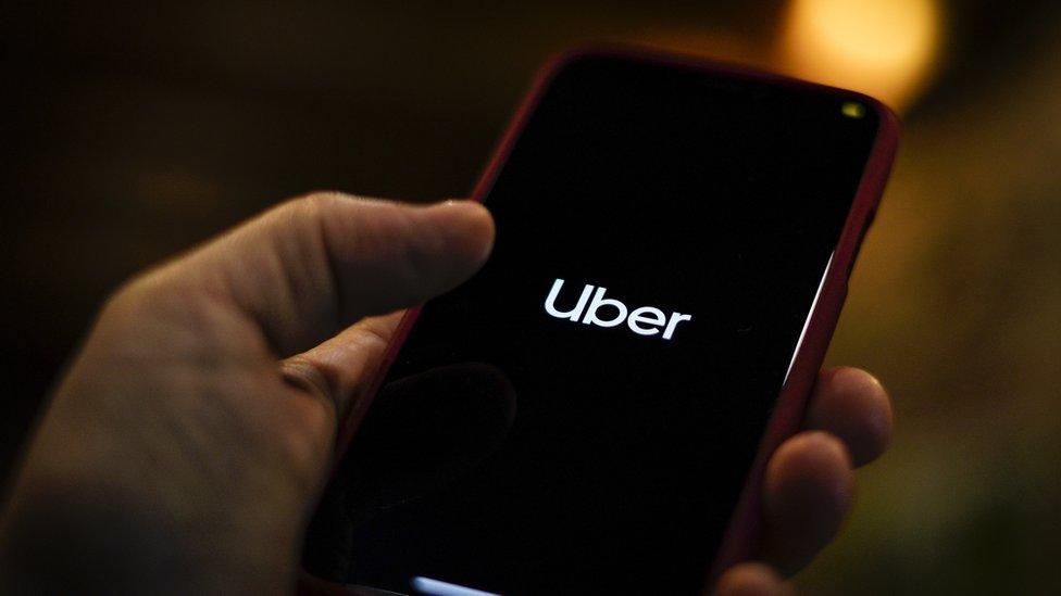 The Uber logo is seen displayed on a mobile device in this photo illustration in Warsaw, Poland on March 19, 2019.