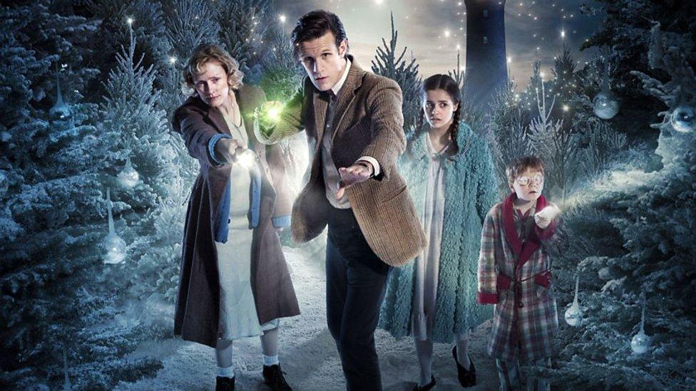 Matt Smiths Doctor surrounded by a family in forest