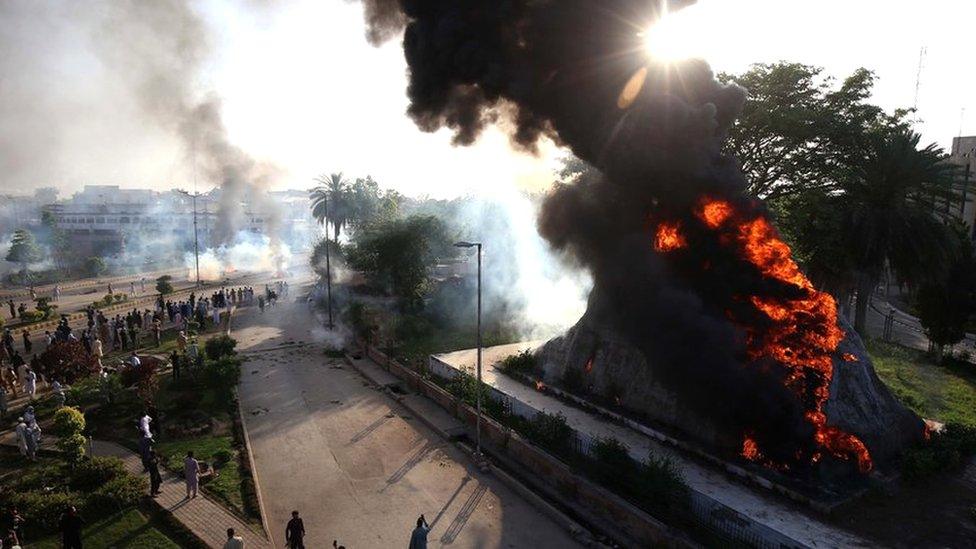 Flames rise from the Radio Pakistan premises after it was set on fire during clashes between police and supporters of Pakistan's former Prime Minister Imran Khan protesting against his arrest, in Peshawar, Pakistan, 09 May 2023.