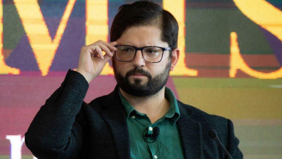 Chilean presidential candidate for the Apruebo Dignidad party Gabriel Boric gestures during a debate at the Chilean Institute of Rational Administration of Companies (ICARE), in Santiago, on November 11, 2021