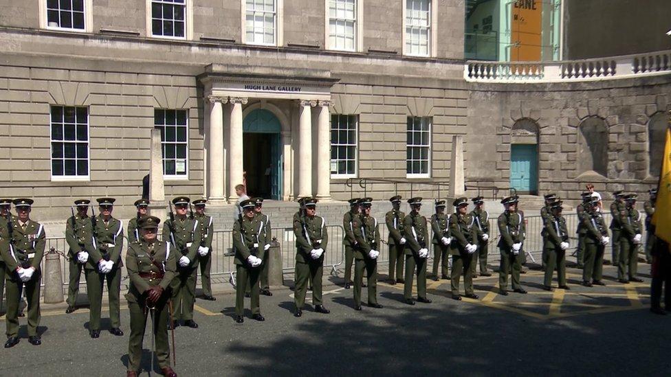 Irish Army soldiers stand to attention in the Garden of Remembrance in Dublin