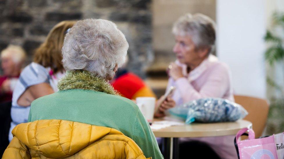 Women seated at table in the Hub in Bangor