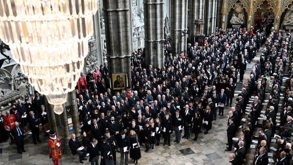 Large crowds in Westminster Abbey, watching the procession.