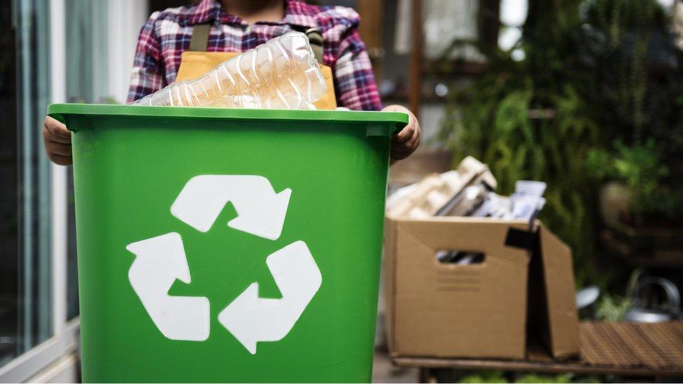 Kid-holding-recycling-box