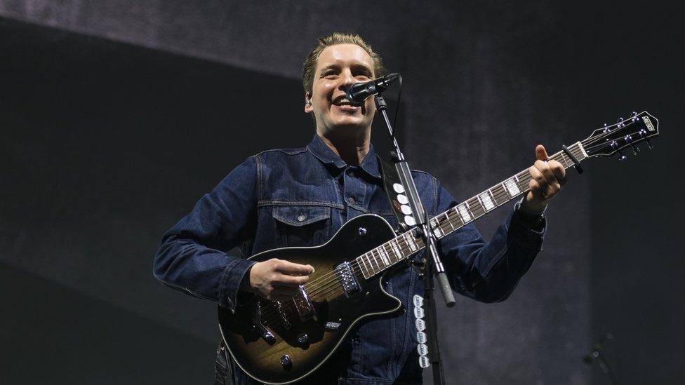 George Ezra smiling on stage