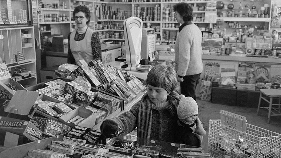 A village grocery stores with customers in Black Torrington, December 1979