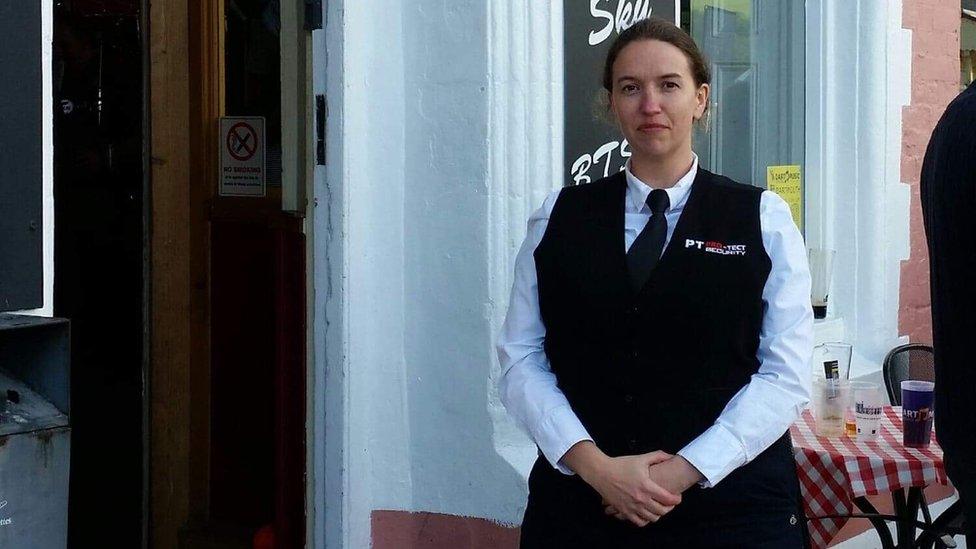 Woman wearing security uniform