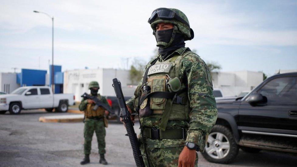 Soldier stands guard outside the morgue