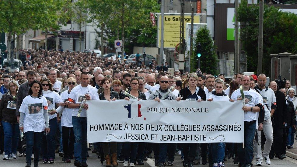 People and policemen take part in a march from Mantes-la-Jolie, western suburbs of Paris, on June 16, 2016, in tribute to French policeman Jean-Baptiste Salvaing and his partner Jessica Schneider killed outside their home in the Paris suburb of Magnanville.