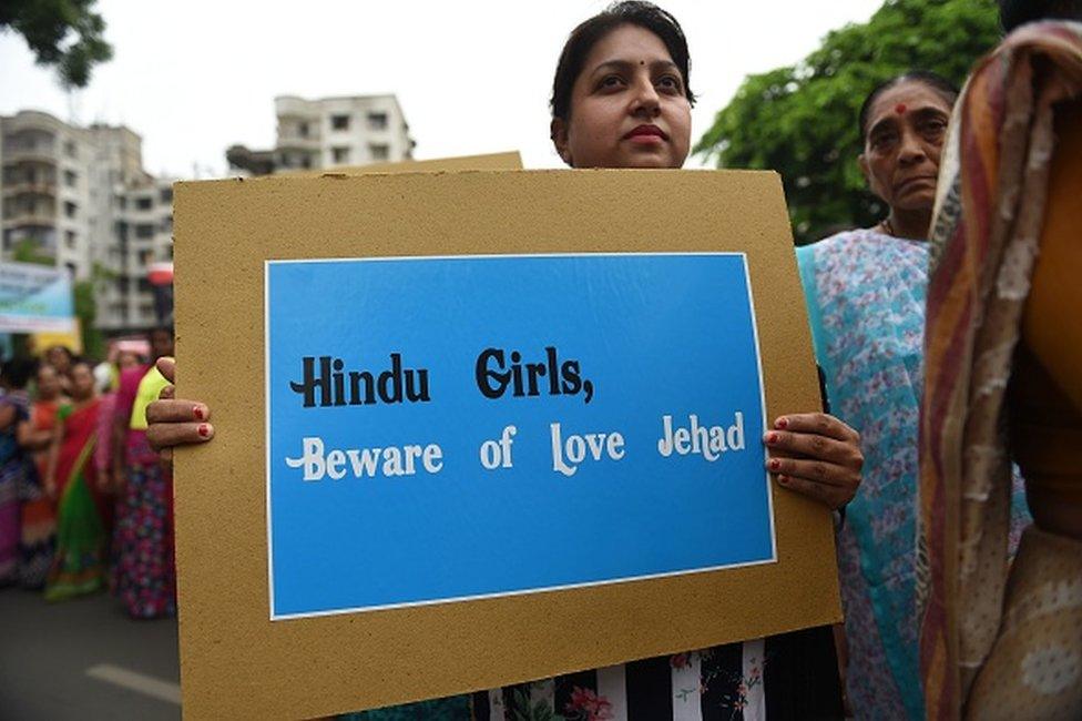 An Indian Hindu holds a placard as she takes part in a rally against 'Love Jihad', in Ahmedabad on July 22, 2018.