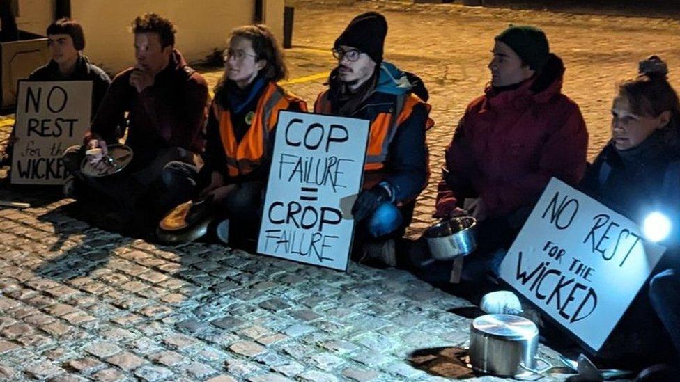 Protesters sit on the floor outside Sunak's home