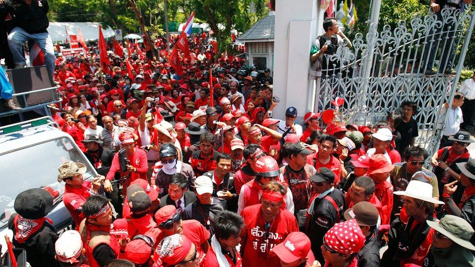 Protesters in red shirts