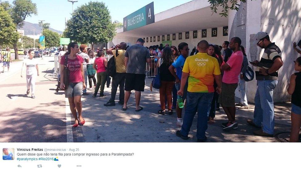 A photograph shows people queuing to get Paralympic tickets