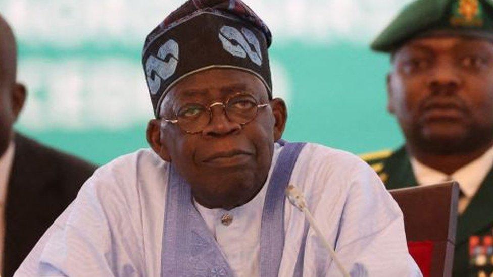 Chairperson of Economic Community of West African States (ECOWAS) and President of Nigeria, Bola Ahmed Tinubu, reacts while addressing the ECOWAS head of states and government in Abuja on July 30, 2023