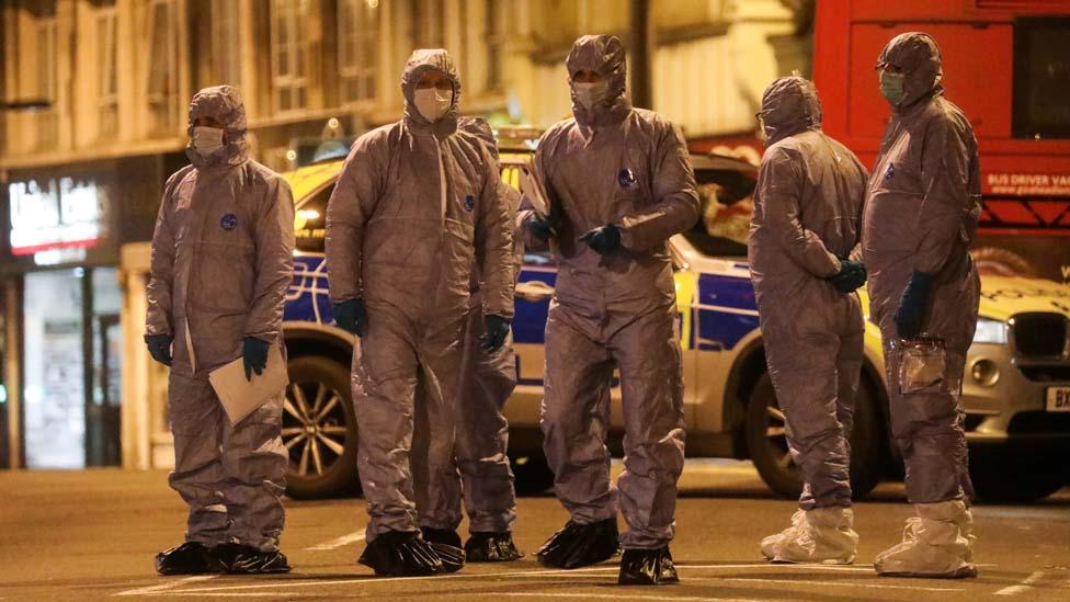 Police forensics officers are seen near a site where a man was shot by armed officers in Streatham, south London