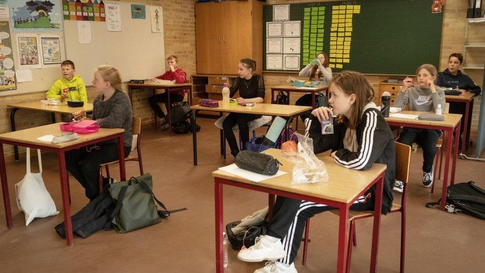 Children back in school in Denmark, sitting far apart