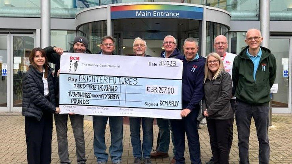 Rodney Cook Memorial team hand cheque to Brighter Futures charity