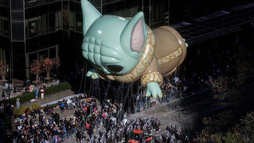 The Baby Yoda balloon floats during the parade