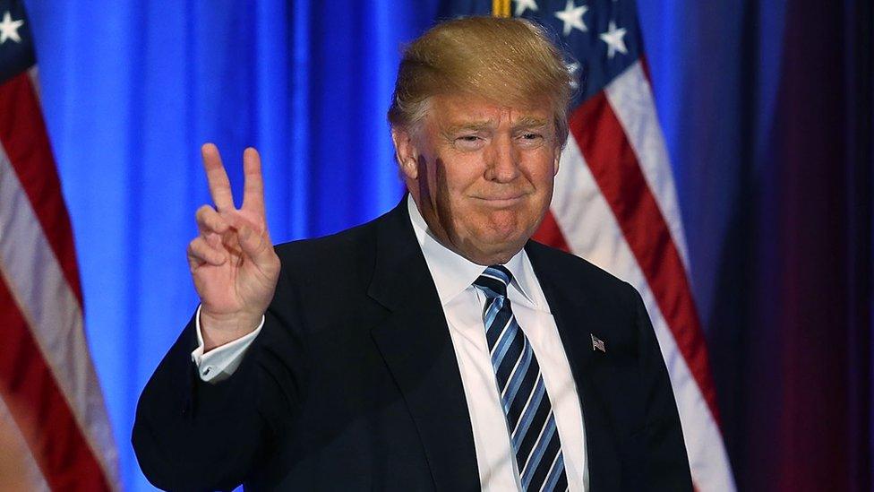 Trump flashes a "V for victory" hand sign in Florida.