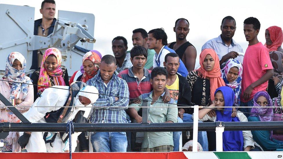 Migrants wait to disembark from the Italian Coast Guard ship Fiorillo in the harbour of Pozzallo, near Ragusa, Sicily, Italy (7 August 2015)