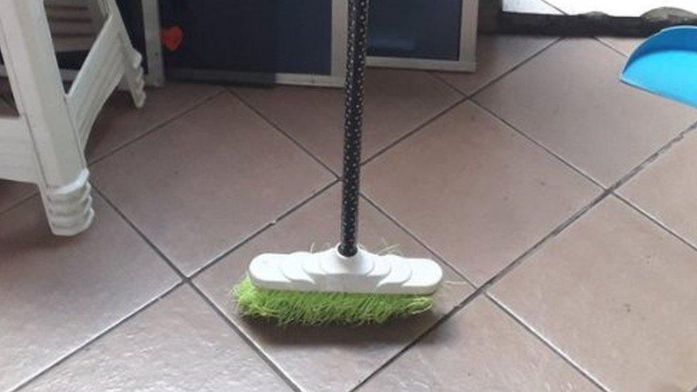 Broom standing upright