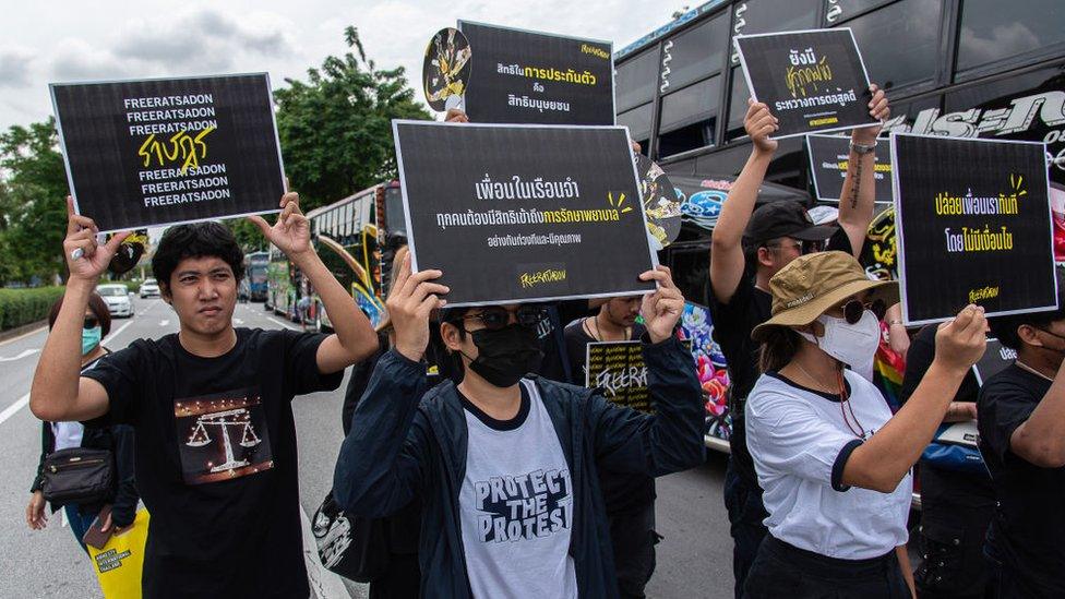 Thai Amnesty International activists hold placards during a demonstration in Bangkok calling for the release of political prisoners convicted under the lese majeste law on 26 September 2023