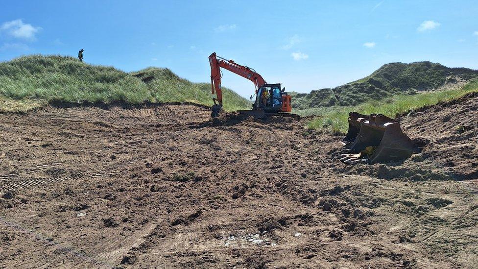 A digger at Penhale Dunes