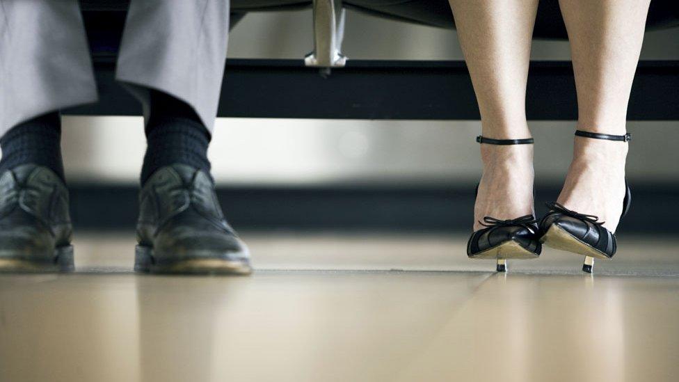 A man's feet next to a woman's feet