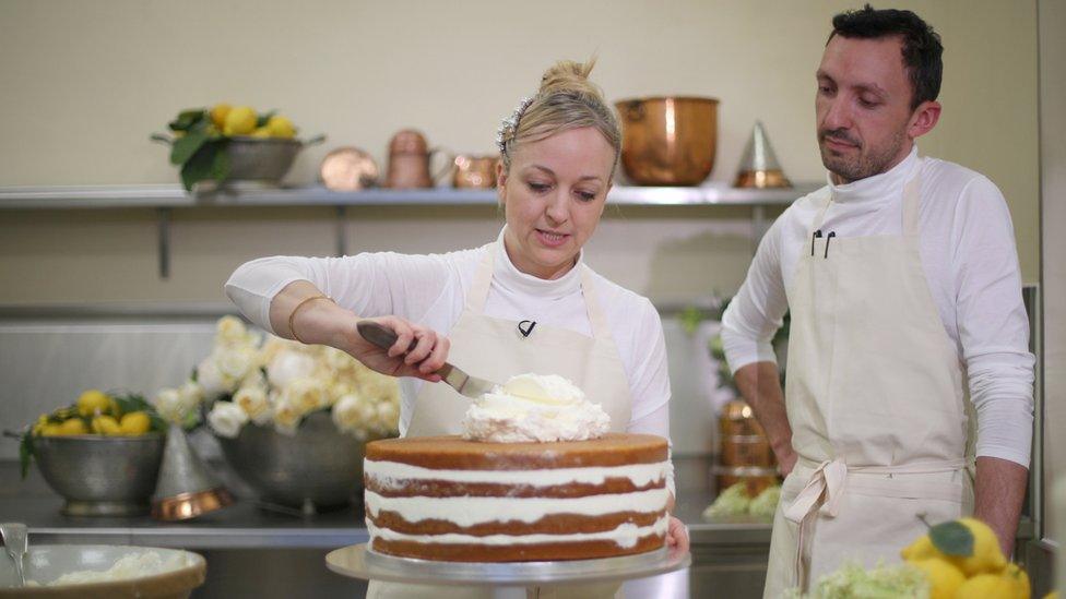 Claire icing the cake