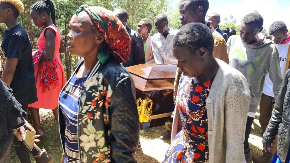 Family walking by the coffin of Edwin Chiloba in Kenya - 17 January 2023