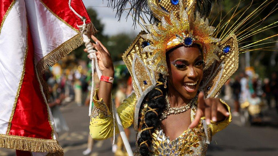 A samba dancer impresses with a striking gold headress