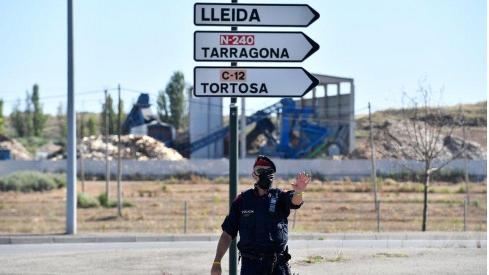 A police officer enforcing a lockdown around Lleida