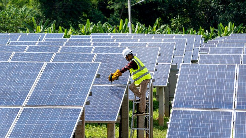 Engineers checking and repairing solar panel at generating power of solar power plant