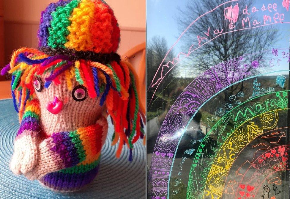 Knitted rainbow figure and rainbow painted on window