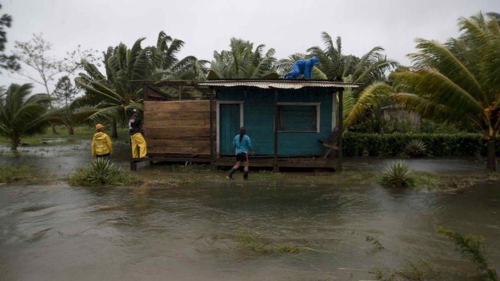 People secure walls and roof of a house amid heavy rains brought by Hurricane Eta, in Bilwi, Nicaragua, 03 November 2020.