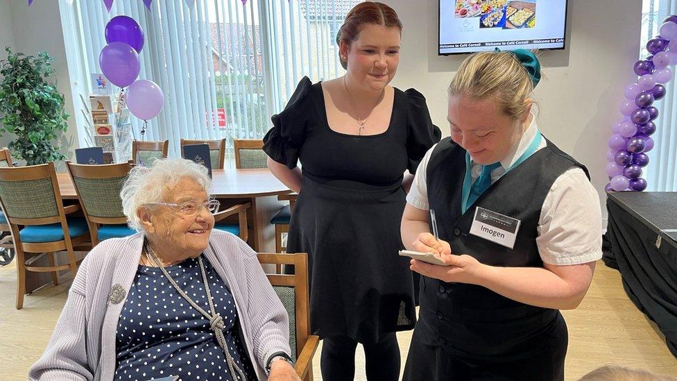 Staff serving a woman at Cafe Cornell in Saffron Walden