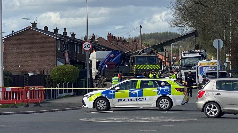 Overturned crane near house in Wigan