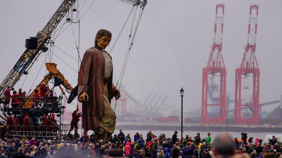 Giant Man walks along the promenade at New Brighton