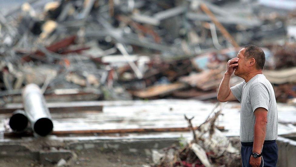 Masashi Chiba, 63, cries as he prays for his daugther who worked at Minamisanriku City Hall Disaster Prevention Center and lost her life in the March 11 earthquake and tsunami on June 11, 2011 in Minamisanriku, Miyagi, Japan.