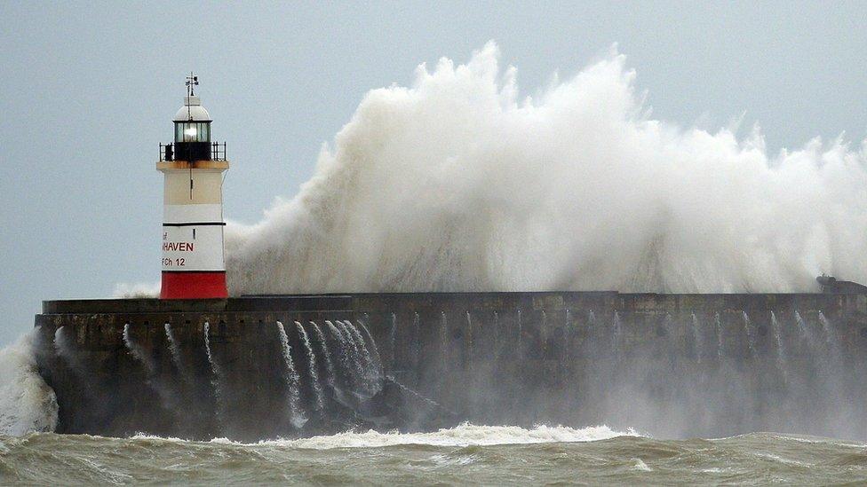 Waves crash against Newhaven Lighthouse