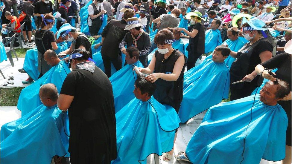 Residents shave in protest in park in Seongju