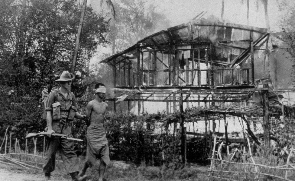 Caption:A British soldier with a Japanese sniper he captured near Pegu, Burma (Jan 1945)