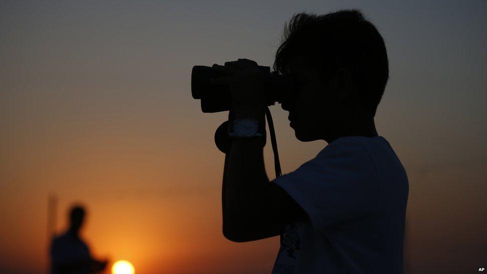 A boy looks on at Turkish military positions