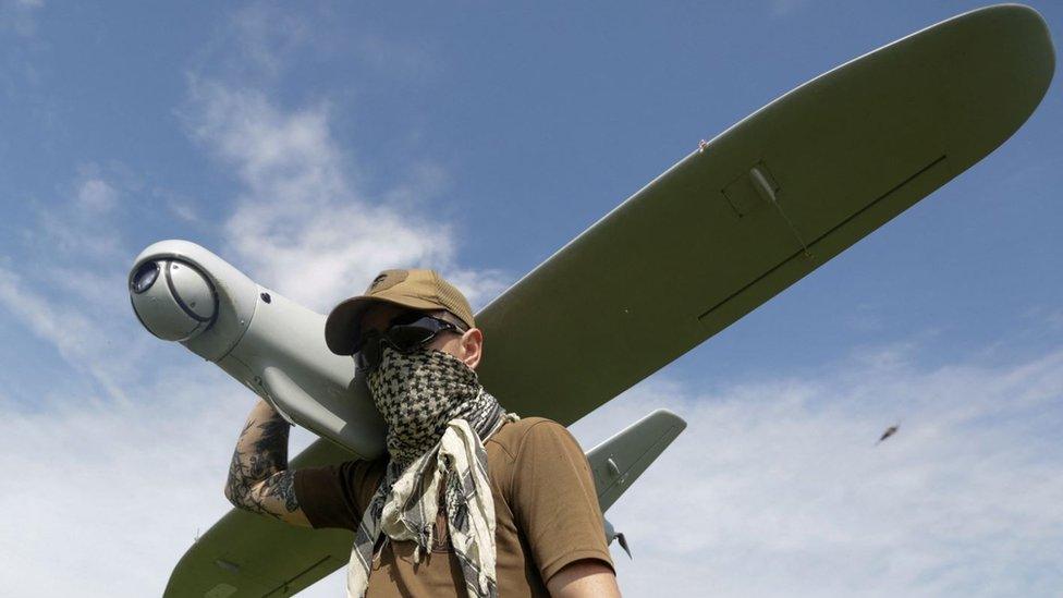 Ukrainian soldier holds a drone